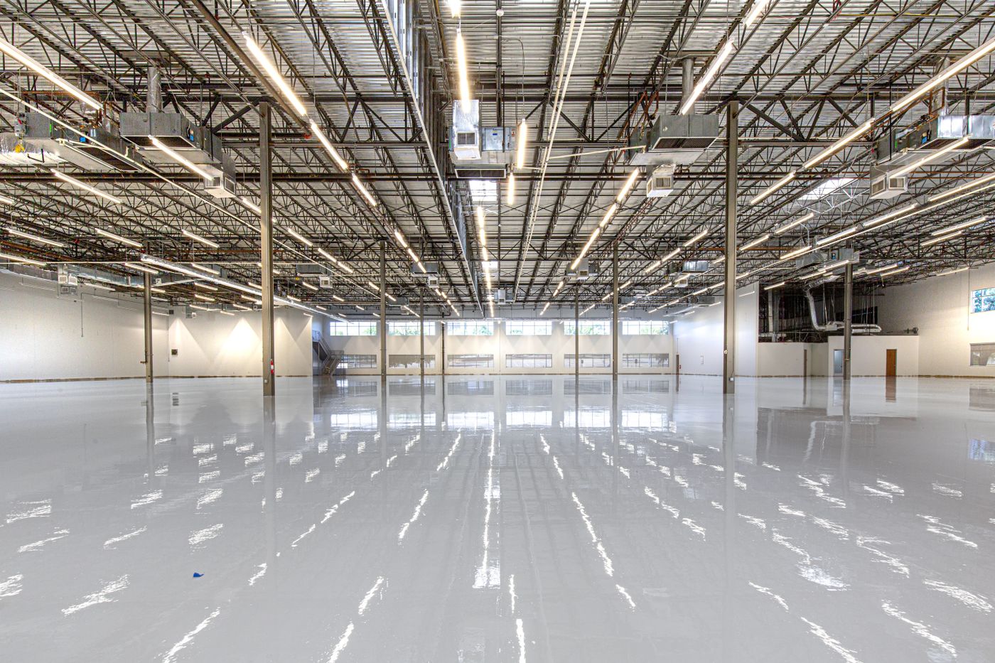 Example photograph of a poured epoxy floor in a commercial space, shown to illustrate the finish rather than a Gargus Wood Floors job.