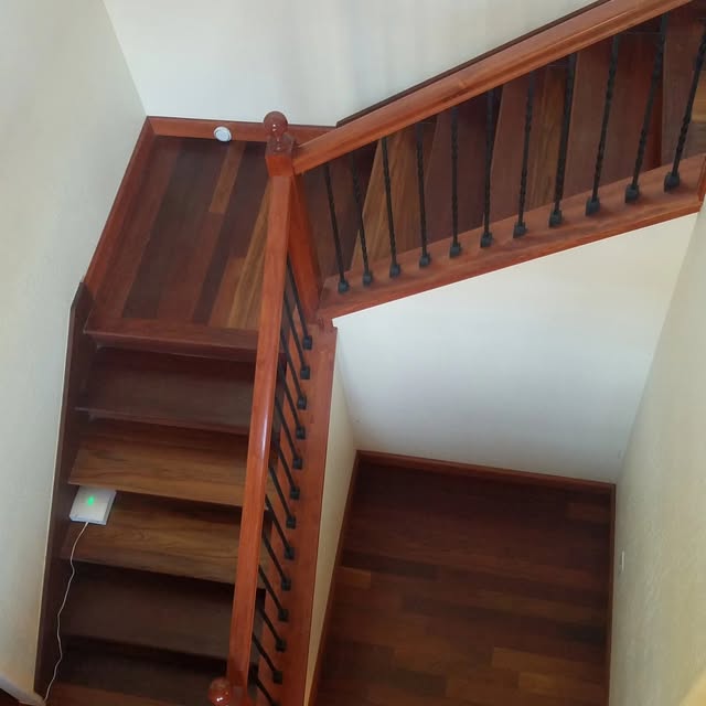 Wood stair treads on a straight run of stairs.